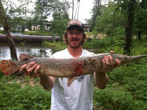 clayton miller holding alligator gar